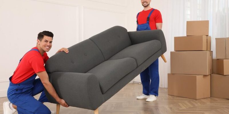 professional-movers-carrying-sofa-new-house_495423-38422